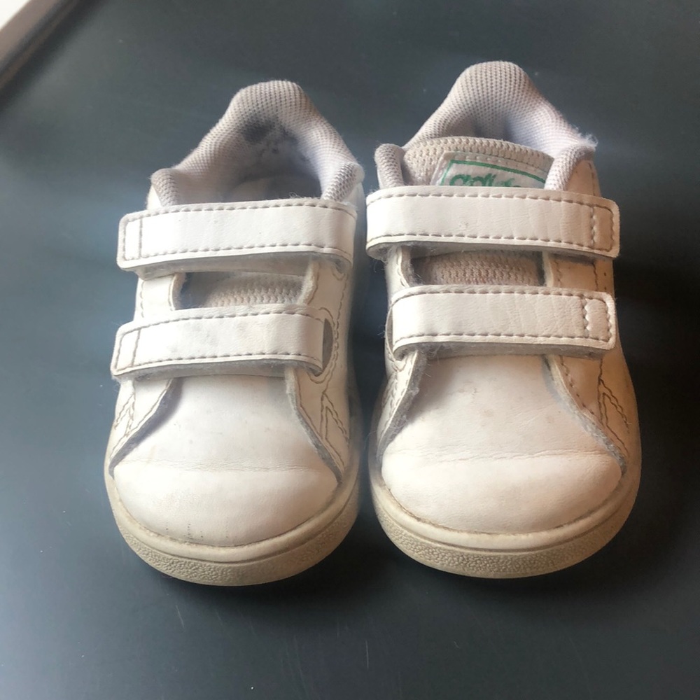 White infant adidas shoes. A little worn out.
